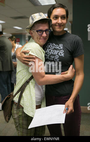 Catherine Simonsen (hat and shorts) and Laura Rivera celebrate while applying for a marriage license on June 26, 2016. Stock Photo