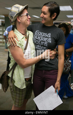 Catherine Simonsen (hat and shorts) and Laura Rivera celebrate while applying for a marriage license on June 26, 2016. Stock Photo