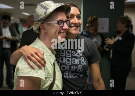 Catherine Simonsen (hat and shorts) and Laura Rivera celebrate together while applying for a marriage license on June 26, 2016. Stock Photo
