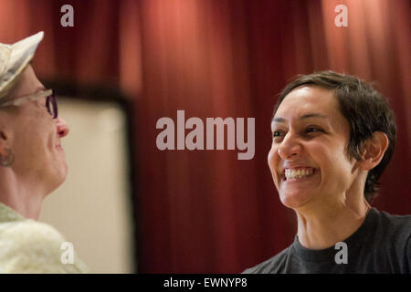 Laura Rivera expresses her delight while marrying her partner, Catherine Simonsen (hat and shorts.) Stock Photo