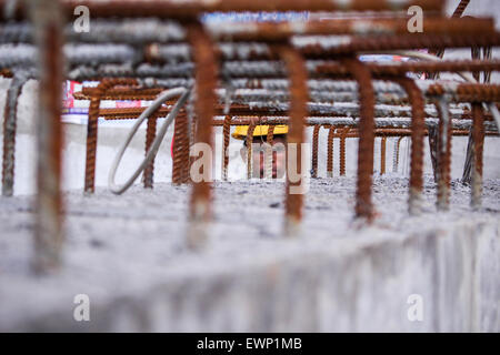 Dhaka, Bangladesh. 29th June, 2015. The face of a construction worker is seen through the pattern of rods at the construction site of a fly-over. The construction of Moghbajar Fly-over generates work for some people in Dhaka. © Belal Hossain Rana/Pacific Press/Alamy Live News Stock Photo