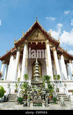Buddhist temple architecture of Wat Suthat Thep Wararam under blue sky in Bangkok Thailand Stock Photo