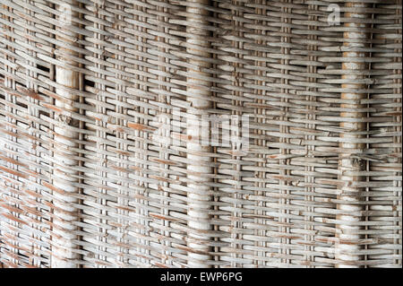 Textured woven rattan wood wicker background with structural supports in neutral white and beige Stock Photo