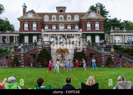 Old Westbury, New York, USA. 28th June 2015. Lori Belilove & The Isadora Duncan Dance Company, dressed in Renaissance themed tunics, perform on the South Lawn in front of the Mansion of historic Old Westbury Gardens, a Long Island Gold Coast estate, for its Midsummer Night event. Credit:  Ann E Parry/Alamy Live News Stock Photo