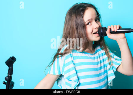 girl sing in a microphone Stock Photo