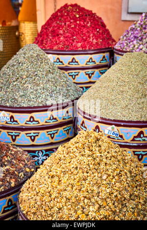 Ceramic pots of dried flowers, rose petals, buds and herbs in the souk. Morocco Stock Photo