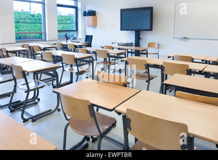 Empty classroom with tables and chairs in school building Stock Photo