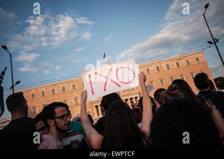 A woman holds a placard outside the Greek parliament reading 'NO' during a demonstration calling for 'NO' at referendum in Athens, Greece on the 29th of June 2015. Photo: Socrates Baltagiannis/dpa Stock Photo