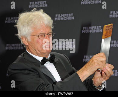 Munich, Germany. 29th June, 2015. French director Jean-Jacques Annaud poses with his CineMerit Award at the film festival in Munich, Germany, 29 June 2015. The Munich International Film Festival has been honouring outstanding figures in the international film industry with the award since 1997. Photo: Ursula Dueren/dpa/Alamy Live News Stock Photo