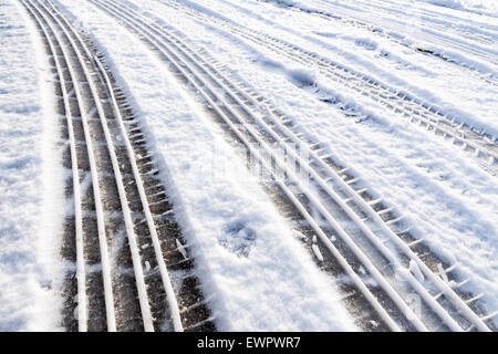 Car tire tracks in snow symbol of transport during winter season Stock Photo