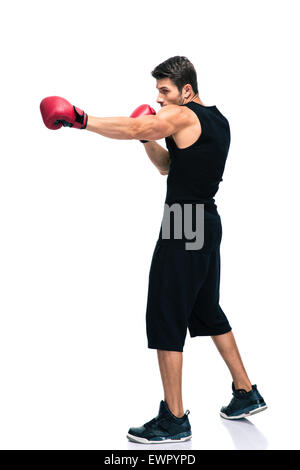 Full length portrait of a sports man boxing in red gloves isolated on a white background Stock Photo