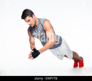 Fitness man doing exercises on the floor isolated on a white background