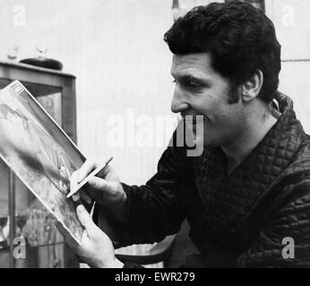 Welsh singing star Tom Jones signs a picture for a fan. 25 October 1966 Stock Photo