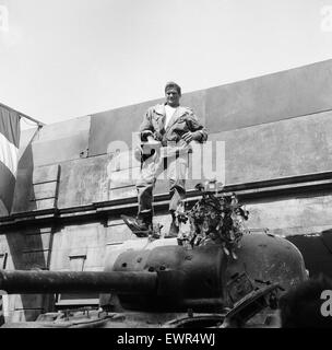 Rod Taylor, on a Sherman tank, on the set of MGM's new film 'The Liquidator'. The film is based in a French village and is being filmed at Elstree Studios. 12th May 1965. Stock Photo