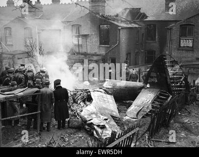 Site of a downed Bristol Blenheim in Bearwood, Birmingham during the Second World War showing emergency services at the scene in a residential street after it collided with a barrage balloon cable. 20th February 1942. Stock Photo