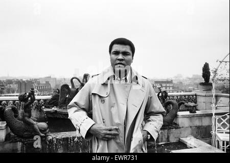 Muhammad Ali, former heavyweight boxing champion, stepping outside into the rain after a press conference at his London hotel.   12th December 1980 Stock Photo