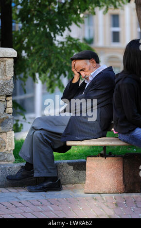 Old man sleeping on a park bench. Stock Photo