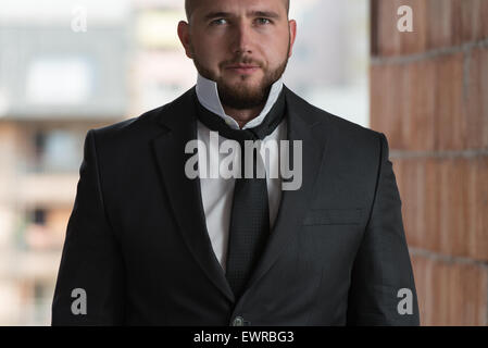 Close Up Of Businessman Adjusting Tie Stock Photo