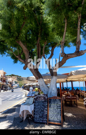 Bar Restaurant bellow tamarisk tree Rethymno Crete Greece seaside taverna Stock Photo