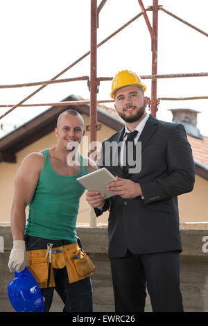 Group Of Male Architect And Construction Worker On Construction Site Stock Photo