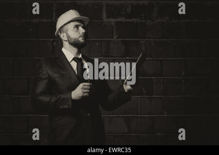 Portrait Of Construction Master With Personal Computer In Hands Stock Photo