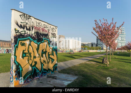 East Side  Park , Berlin Wall Piece, backside of  East Side Gallery, Skyscraper Living Levels, Cherry Blossom Stock Photo