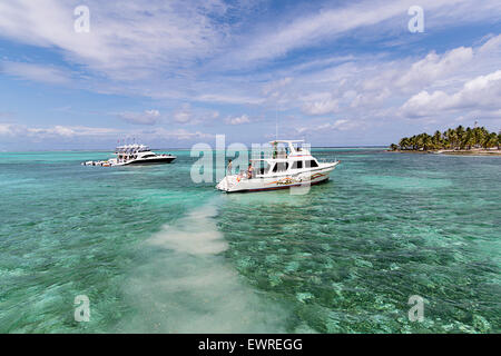 Diving boats anchored off of Half Moon Caye. Stock Photo