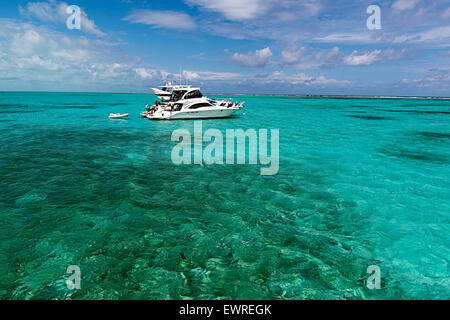 Boats anchored in the waters off of Half Moon Caye. Stock Photo