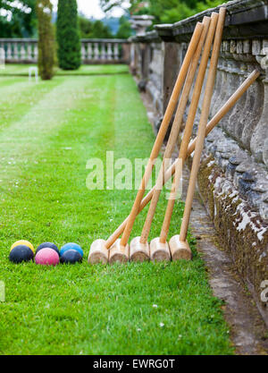 Five croquet bats and six croquet balls on the parterre at Weston Park, Weston under Lizard, Shifnal, Shropshire, England, UK Stock Photo