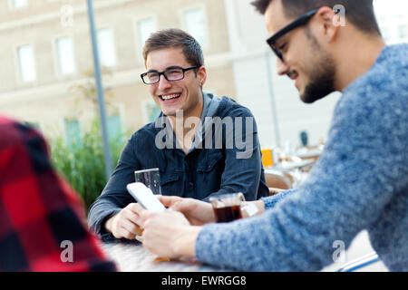 Outdoor portrait of young entrepreneurs working at coffee bar. Stock Photo
