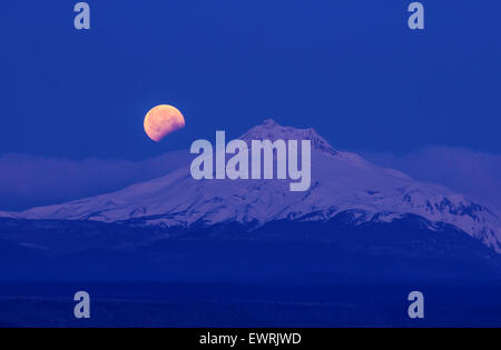 Mt. Jefferson, Oregon, with a partial eclipse of the moon on April 4, 2015 Stock Photo
