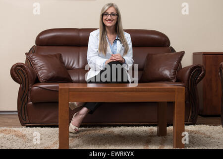 Young Doctor Relaxes Sitting In The Office Stock Photo