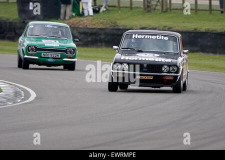 The 1976 Triumph Dolomite Sprint of Ken Clarke ahead of a MKI Escort RS2000 at the Goodwood Members meeting Stock Photo