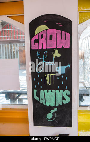 Grow food not lawns sign blackboard at Solar panel roof Restaurant at CAT,Machynlleth,Powys,Wales,MacMachynlleth,Powys,Wales, Stock Photo