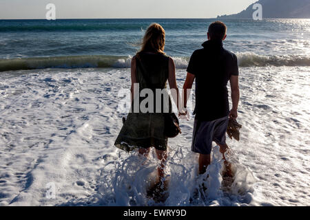 South Crete, People on Greece beach Man woman couple in the surf of the sea people holding hands Stock Photo