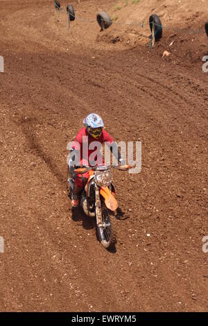 Action adventure Motocross motorcycle race training event. Racing across dirt tracks and leaping in the air, dirt sprays/ Stock Photo