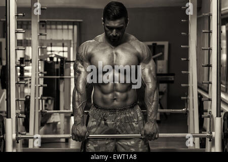 Bodybuilder Doing Heavy Weight Exercise For Trapezius Stock Photo