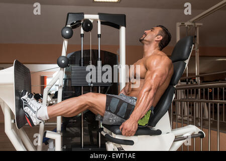 Bodybuilder Doing Heavy Weight Exercise For Legs Stock Photo