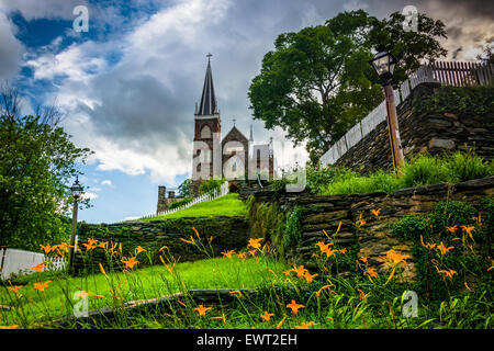 Orange lillies and St. Peters Roman Catholic Church, in Harpers Ferry, West Virginia. Stock Photo