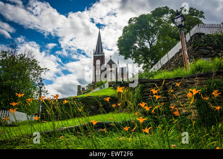 Orange lillies and St. Peters Roman Catholic Church, in Harpers Ferry, West Virginia. Stock Photo