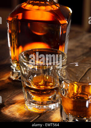 close up view of  nice bottle and two glasses filled with whiskey Stock Photo