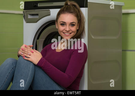 Pretty Smiling Girl In The Laundry Room Stock Photo