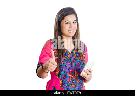 1 indian woman Dialing Cell Phone and thumbs up showing Stock Photo