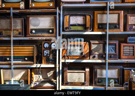 Old retro radios arranged on an antique store shelves. Stock Photo