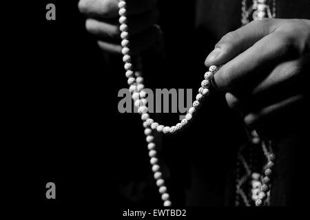 Close-Up Of Young Muslim Man With Rosary Praying In Mosque Stock Photo