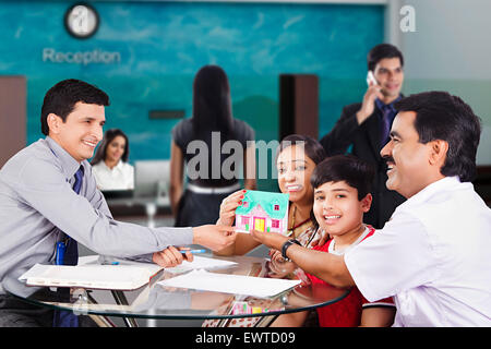 indian Parents and Salesperson House Dealing Stock Photo