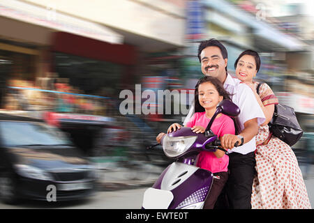 indian Parents and daughter road Riding Scooty Stock Photo