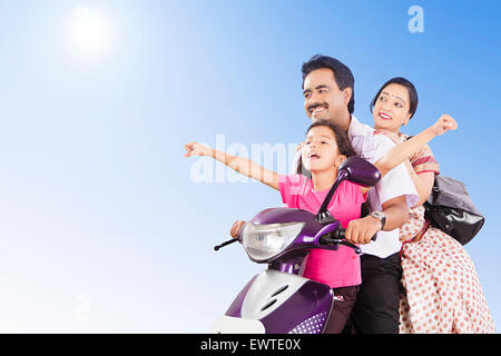 indian Parents and daughter Riding Scooty Stock Photo