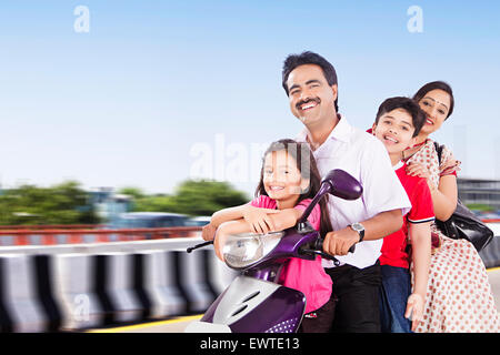 indian Parents and kids road Riding Scooty Stock Photo