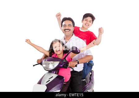 indian father and kids Riding Scooty Stock Photo